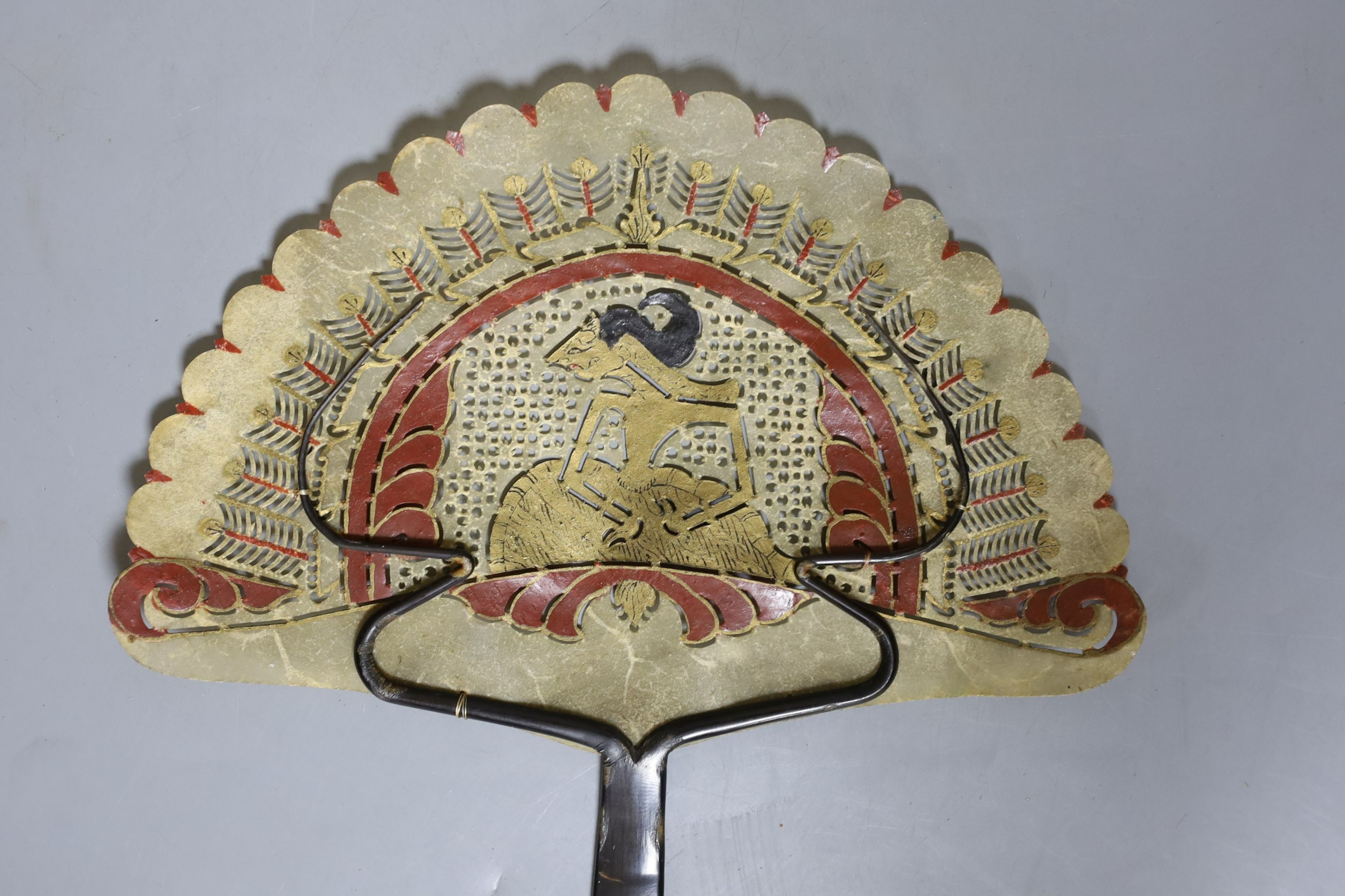A Burmese carved hardwood figure, 51.5cm tall, and a Burmese horn and animal-bladder fan